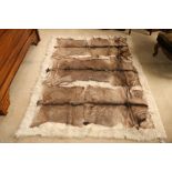 A large goat skin Rug, with three pelts, 198cms x 155cms (78" x 61"). (1)