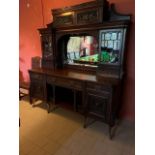 An Edwardian carved mahogany Sideboard Chiffonier, the moulded cornice above two cupboard doors each