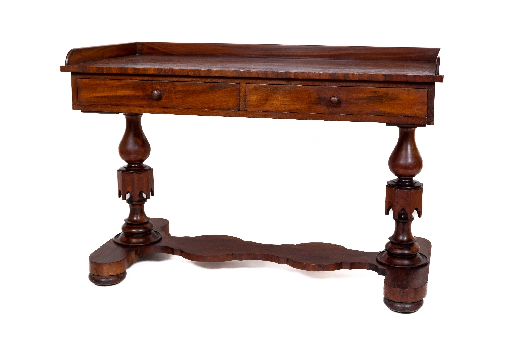 A Victorian mahogany Dressing Table, with three quarter gallery above two frieze drawers on two