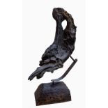 "An Brad n - The Salmon," a natural bog oak design, mounted on a metal stand with wooden base,