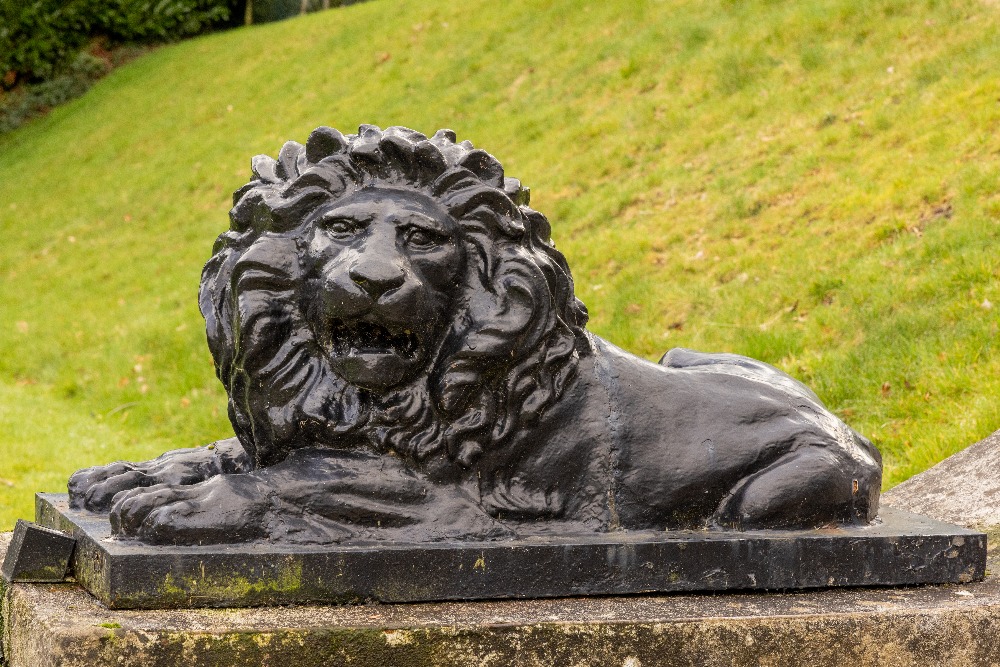 A large pair of heavy bronzed cast iron Figures, of recumbent lions one facing left with open mouth, - Image 2 of 2