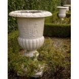 A rare suite of three heavy cast iron relief moulded campana shaped Garden Urns, with egg n' dart