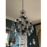 A fine brass and glass French style two tier Chandelier, with four arms above eight arms below, some