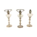 A set of 3 late 19th Century silver plated Candlestick Oil Lamps, with cutglass reservoirs, 32cms (