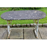 A Victorian cast iron Patio Table, the rectangular slate top with bowed ends on an ornate cast