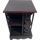 A small Revolving Bookcase, with pierced slatted sides on a shaped plinth, 60cms x 41cms (23 1/2"