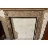 A late 19th Century carved pine Chimneypiece, the leaf moulded shelf above a frieze with a series of