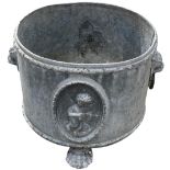 A good cylindrical lead Planter, relief moulded with panels of cherubs and lion mask handles on lion