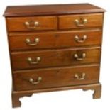 A George III period mahogany Chest, with four long graduating drawers and raised on bracket feet,