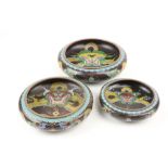 A set of 3 Chinese graduating cloisonné dragon Bowls, each with a four character mark to base, 34cms