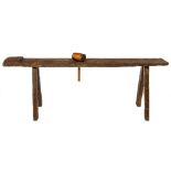 A large old oblong plank top Work Bench, on four rectangular spreading legs; together with a