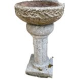 A large carved granite Bird Bath, with circular bowl supported on a fluted column and square stepped