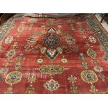 A fine quality semi-antique woollen Carpet, the burgundy ground centre with bouquet of flowers and