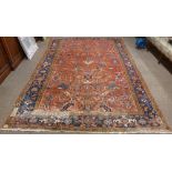 A fine quality semi-antique heavy woollen Carpet, the central panel on burgundy ground with floral