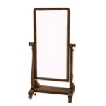 A Victorian mahogany cheval Dressing Mirror, the rectangular swing frame on an S scroll support