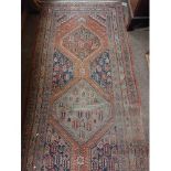 An attractive antique Middle Eastern woollen Carpet Runner,  the central panel on claret ground with