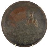 A good Japanese bronzed metal Plate, with figure of Buddha seated in a woodland with tiny bird