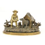 An attractive 19th Century gilt bronze Inkstand, modelled with a young boy feeding a dog by a kennel