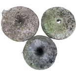 Two old carved stone Oven Wheels, 43cms (17"); together with a large donut shaped ditto. (3)