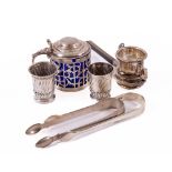 A crested and pierced silver Pot and cover, and blue glass liner, a Novelty swivel Tea Strainer, two