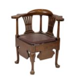 A George III walnut Corner Armchair, with shaped flat arm rests,above two pierced splats and