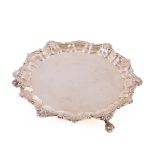 A small silver Salver, London 1898, by C.B., of circular shell and scroll cast edge on three ball n'