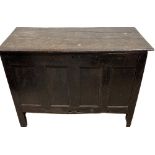 A large heavy oak Chest or Coffer, 18th Century and later with lift plank top above four panel front