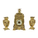 A three piece late 19th Century ornate French brass Clock Garniture, the clock with a pierced dome