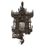 A 19th Century carved wooden Thai or Burmese Wall Shrine, profusely carved with religious icons,