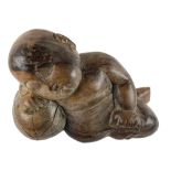 A large carved Thai Figure of a sleeping infant boy with a melon as a pillow, 46cms (18"). (1)