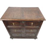 A late 17th Century oak Chest, of small proportions with three long double panel drawers on square