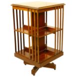 An Edwardian mahogany Revolving Bookcase, with latted sides on an X frame base, approx. 86cms