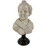 A small carved white marble Bust, of a young woman wearing a bonnet, on a dark veined marble