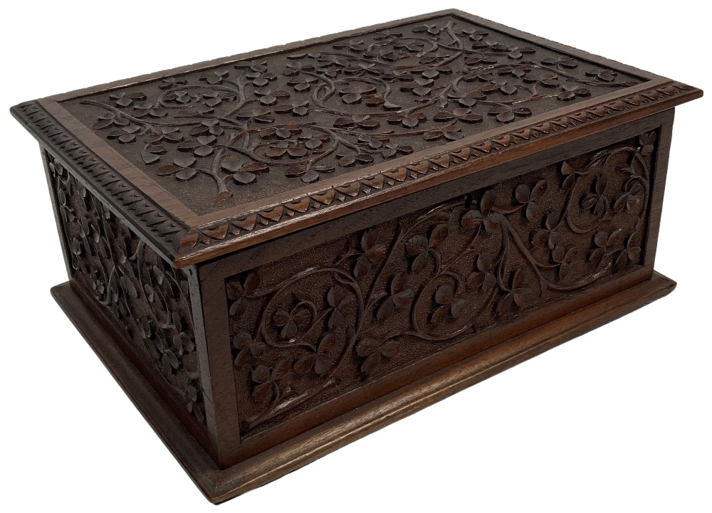 A fine carved Irish mahogany Box, by "The Kilkenny Woodworkers," with fragment of label, the