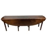 An Irish Georgian style mahogany drop leaf Hunt or Wakes Table, with demi-lune flaps raised on six