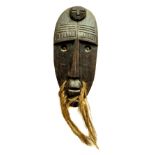 A good carved wooden African Tribal Mask, with hairy whiskers and oval face with copper inset