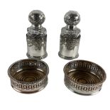 A good pair of small glass Decanters and stoppers, each in an ornate silver plated coaster and a