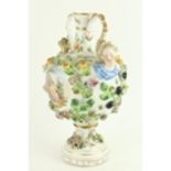 An attractive German porcelain two handled hand painted and floral encrusted Urn, each side with