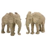 A pair of moulded composition Models of African Elephants each with faux ivory tusks, 24cms (9 1/