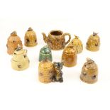 A collection of Devon, Portugal, Japanese and other beehive shaped and other ceramic Honey Pots. (