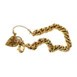 A heavy 9ct gold chain link Bracelet, with heart shaped lock and safety chain, 35.3cms. (1)