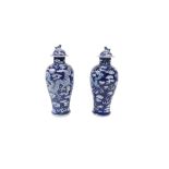 A good pair of Chinese blue and white baluster shaped Dragon Vases, with covers, each with four