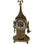 An attractive French style Cathedral brass Mantel Clock, the top surmounted with dragon, with