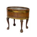 An Irish Georgian period oval shaped and latted brass bound Wine Cooler, with metal liner, on