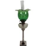 An attractive 19th Century Oil Lamp, with green etched glass shade over a clear glass reservoir,
