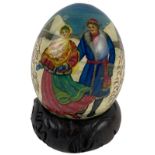 A fine and rare Russian egg form polychrome Figure, decorated with a Russian couple in a snow