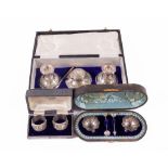 A cased silver Desk Set, comprising a pair of Candlesticks, London 1924, a matching Pot and a pen,