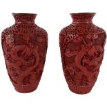 An attractive pair of 19th Century cinnabar and metal Chinese Vases, and floating five claw dragons,