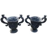 A pair of very heavy old two handled lead Garden Urns, each with two caryatid handles, a cherub mask