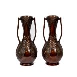 An exceptional pair of Japanese Art Nouveau Meiji bronze Vases of bottle form and lily handles